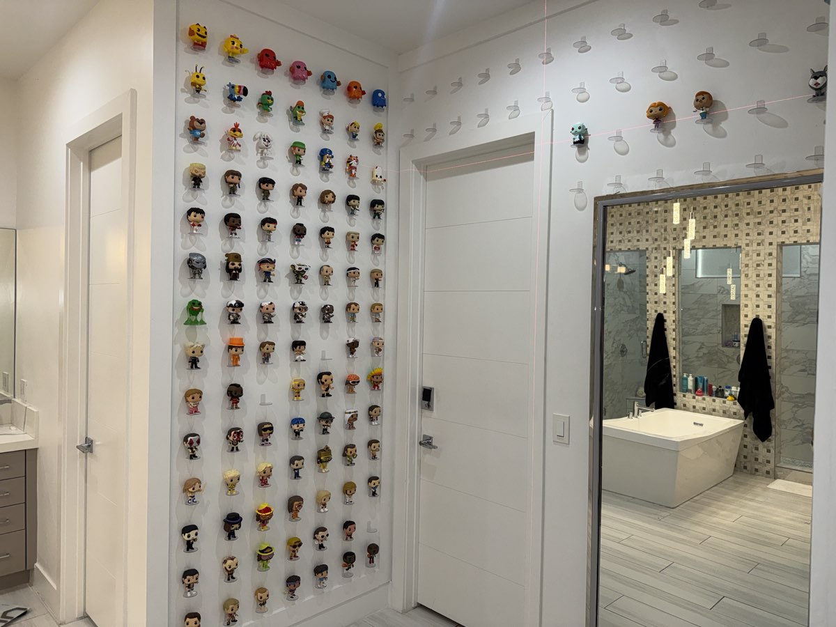 After: floor-to-ceiling Funko Pop display wall, custom mounted, Las Vegas home